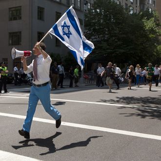 New York City mayoral candidate and former U.S. Rep. Anthony Weiner waves an Israeli flag as he marches up New York's Fifth Avenue in the Israel Day Parade Sunday June 2, 2013. Weiner has been absent from the annual parade since 2011, when he became entangled in a Twitter scandal involving a below-the-belt photo. “It’s great, if feels great, this is home to me,” he said. “I’m, kind of like a thoroughbred in a stable, ready to hit the starting line.” (AP Photo/Cassandra Giraldo)