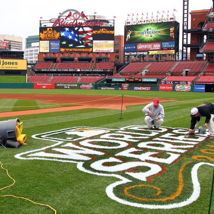 ST LOUIS, MO - OCTOBER 18: Workers paint a 2011 World Series logo on the field at Busch Stadium on October 18, 2011 in St Louis, Missouri.The Texas Rangers will take on the St. Louis Cardinals in Game One of the 2011 World Series on October 19. (Photo by Dilip Vishwanat/Getty Images)