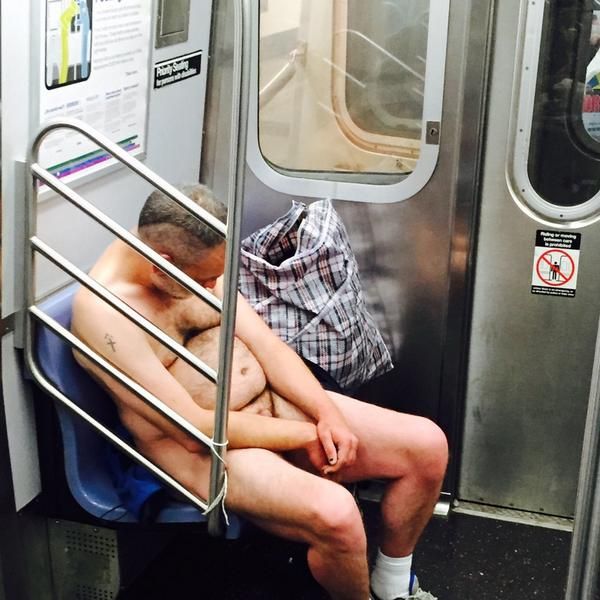 Man Wearing Nothing But Sneakers Dozes, Swigs Jack Daniels on the Subway photo