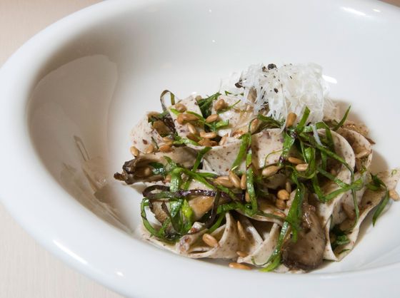 Quinoa tagliatelle with beet greens, maitake mushrooms, and sunflower kernels.