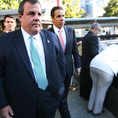 New Jersey Gov. Chris Christie (L) and New York Gov. Andrew Cuomo walk after seeing Hector Garcia (2R) as he watches over his wife Carmen as she hugs the inscribed name of her daughter Marilyn who was killed in the north tower of the WTC during observances for the eleventh anniversary of the terrorist attacks on lower Manhattan at the World Trade Center site September 11, 2012 in New York City. The nation is commemorating the eleventh anniversary of the September 11, 2001 attacks which resulted in the deaths of nearly 3,000 people after two hijacked planes crashed into the World Trade Center, one into the Pentagon in Arlington, Virginia and one crash landed in Shanksville, Pennsylvania.
