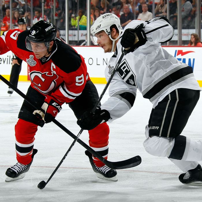 Dustin Brown #23 of the Los Angeles Kings skates with the puck against Zach Parise #9 of the New Jersey Devils during Game Five of the 2012 NHL Stanley Cup Final at the Prudential Center on June 9, 2012 in Newark, New Jersey. 