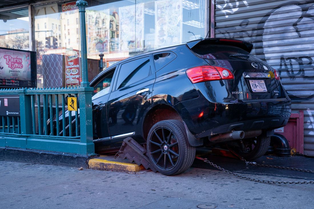 A black Nissan SUV sits in a 1-train staircase at West 157th Street and Broadway after crashing into it on November 24.
