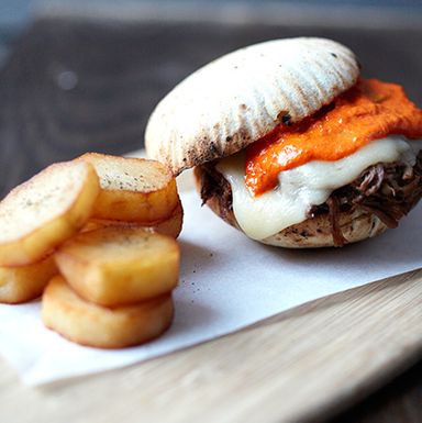 Mollete sandwich with sliced lamb loin, manchego cheese, and a piquillo ali-oli