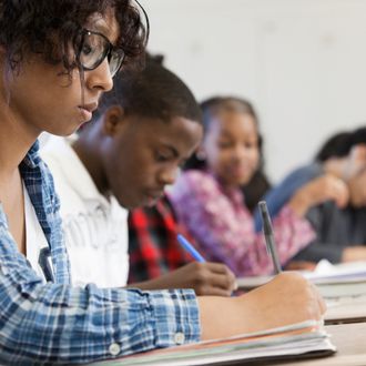 Students writing in classroom.