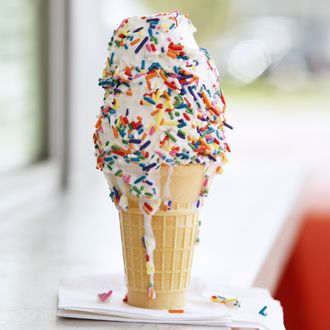 Melting Vanilla Soft Serve Ice Cream Cone with Sprinkles