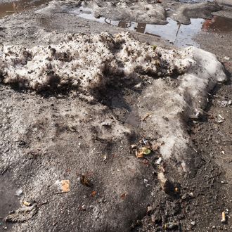 11 Mar 2015, Manhattan, New York City, New York State, USA --- New York, United States. 11th March 2015 -- Dirty chunks of ice, as hard as concrete, collected over numerous snow storms and days of freezing temperatures remain on the New York streets defying the recent rain and warm weather. -- Temperatures in the 50's and seasonable temperatures in the 40's later this week may cause New Yorkers to bid goodbye to these cold weather memories. --- Image by ? Richard Levine/Demotix/Corbis