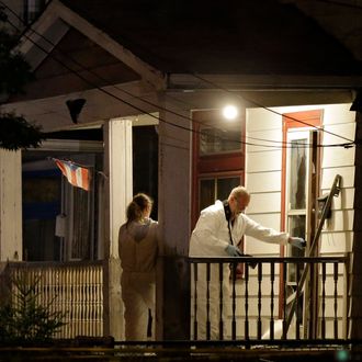 Investigators enter a house on the west side of Cleveland Monday, May 6, 2013 where police say three women were found. The women who went missing separately about a decade ago, when they were in their teens or early 20s, were found alive in the house, and a man was arrested. (AP Photo/Mark Duncan)