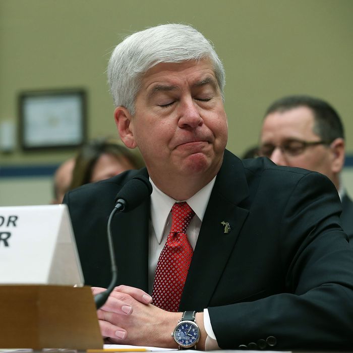 A photo of Michigan governor Rick Snyder with his eyes closed.