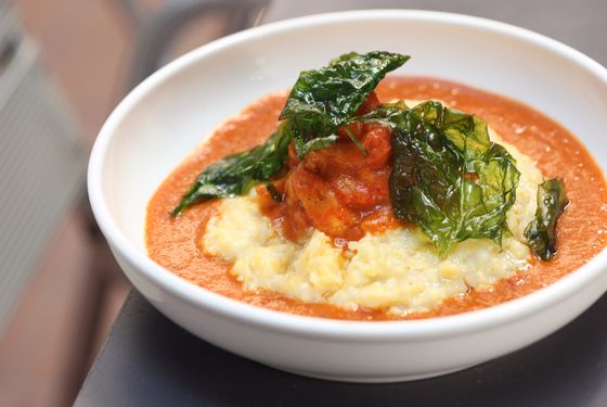 Crawfish etouffee with buttermilk grits and crispy spinach.