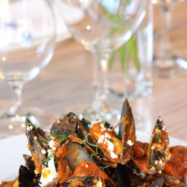 Not-so-classic Greek taverna mussel saganaki in a spicy tomato sauce with smoked feta