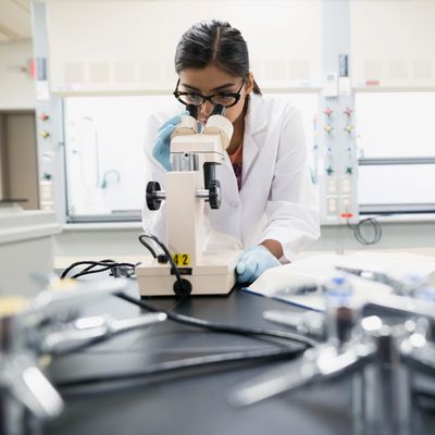 Scientist using microscope in laboratory