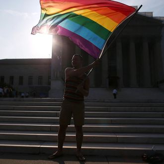 Gay rights activist Vin Testa of DC, waves a flag in front of the U.S. Supreme Court building, June 26, 2013 in Washington DC. Today the high court is expected to rule on California's Proposition 8, the controversial ballot initiative that defines marriage as between a man and a woman 