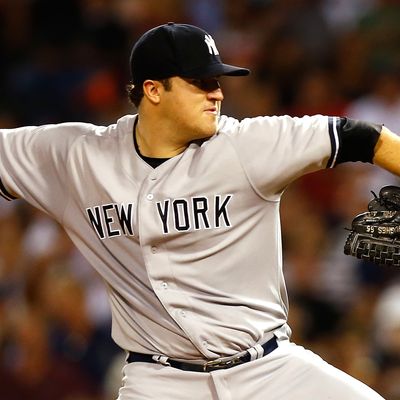 Phil Hughes #65 of the New York Yankees pitches against the Boston Red Sox during the game on September 13, 2012 at Fenway Park in Boston, Massachusetts.