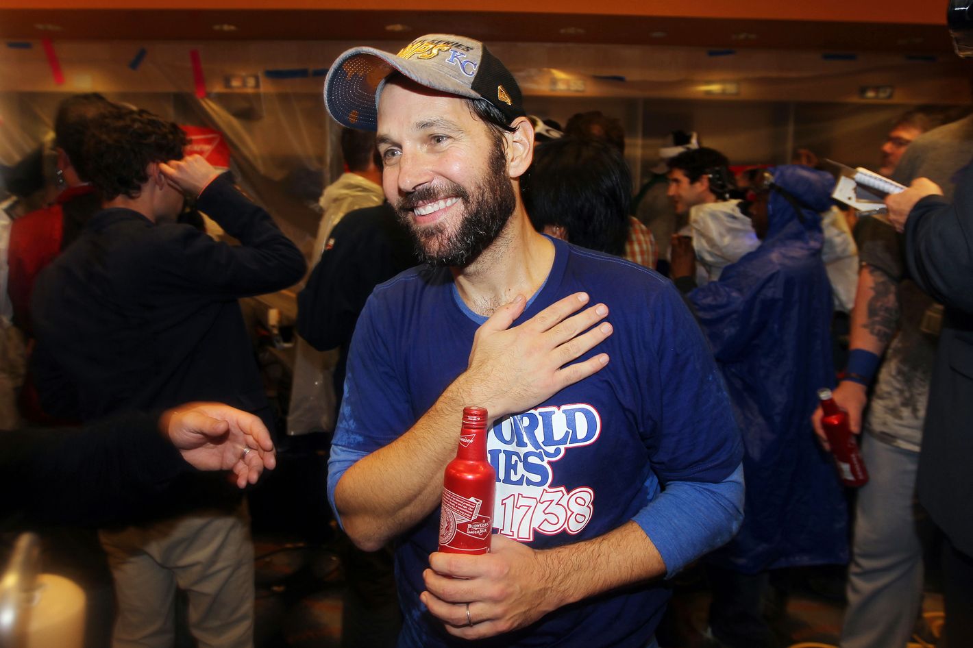 Comedian Paul Rudd, left, put on a Kansas City Royals shirt and