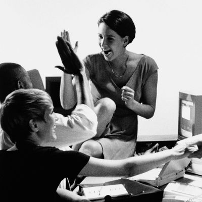 Group of executives celebrating in boardroom (B&W)