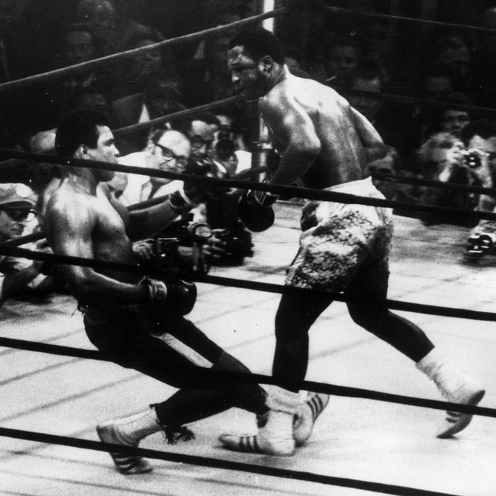 March 1971: In a title fight at Madison Square Gardens, New York, Muhammad Ali goes down in the 15th round to a left hook from world heavyweight champion Joe Frazier who kept the title with an unanimous points win. Cameramen are crowded round the ring. (Photo by Keystone/Getty Images)