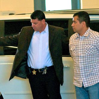 SANFORD, FL- JUNE 3: George Zimmerman (R) is escorted out of a van in to the Seminole County Jail as he surrenders to authorities after he had his bond revoked because of allegedly misleading the court about his finances June 3, 2012 in Sanford, Florida. George Zimmerman who claims he was acting in self defense has been charged with the murder of unarmed teenager Trayvon Martin. (Photo by Roberto Gonzalez/Getty Images)