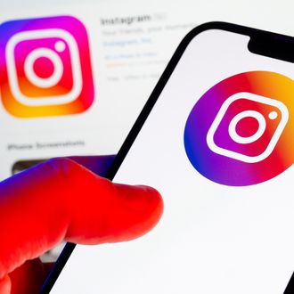 In this photo illustration, an Instagram logo seen displayed