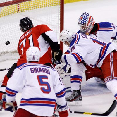 Ottawa Senators' Nick Foligno (71) scores on New York Rangers goaltender Martin Biron as Rangers' Dan Girardi and Marc Staal, defend during first period NHL hockey action in Ottawa, Ontario, on Thursday March 8, 2012. 