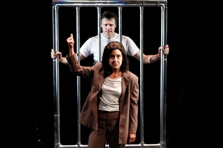 In this theater publicity image released by Jim Randolph Media Relations, Brent Barrett portrays Hannibal Lecter, background, and Jenn Harris portrays Clarice Starling in a scene from "Silence! The Musical," in New York. The musical is a parody of “The Silence of the Lambs.” (AP Photo/Jim Randolph Media Relations, Carol Rosegg)