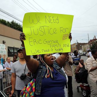 NEW YORK, NY - JULY 19: People participate in a demonstration against the death of Eric Garner after he was taken into police custody in Staten Island on Thursday on July 19, 2014 in New York City. New York Mayor Bill de Blasio announced in a news conference yesterday that there will be a full investigation into the circumstances surrounding the death of Garner. The 400-pound, 6-foot-4 asthmatic, Garner (43) died after police put him in a chokehold outside of a convenience store for illegally selling cigarettes. (Photo by Spencer Platt/Getty Images)