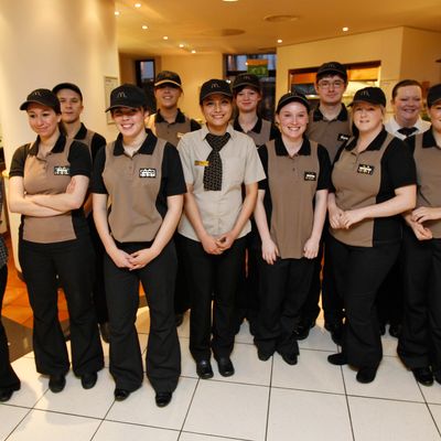 McDonald's staff pose for a photo during a visit from Britain's Deputy Prime Minister Nick Clegg at a training session at the McDonald's Training Center on January 24, 2012 in London, England. McDonald's announced today at least 2,500 new UK jobs this year would be created by the fast food giant. The burger chain expects more than a half of the new posts to go to young people and around 30 percent to first-time workers.