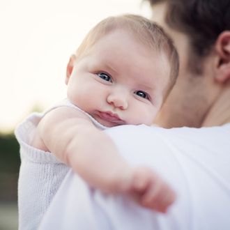 Cute Baby looking over Daddy's Shoulder