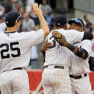 NEW YORK, NY - SEPTEMBER 21: Mark Teixeira #25, Alex Rodriguez #13 and Robinson Cano #24 of the New York Yankees celebrate after defeating the Tampa Bay Rays on September 21, 2011 at Yankee Stadium in the Bronx borough of New York City. (Photo by Jim McIsaac/Getty Images)
