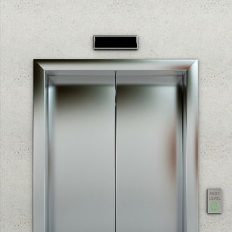 Front view of a modern elevator with closed doors in lobby