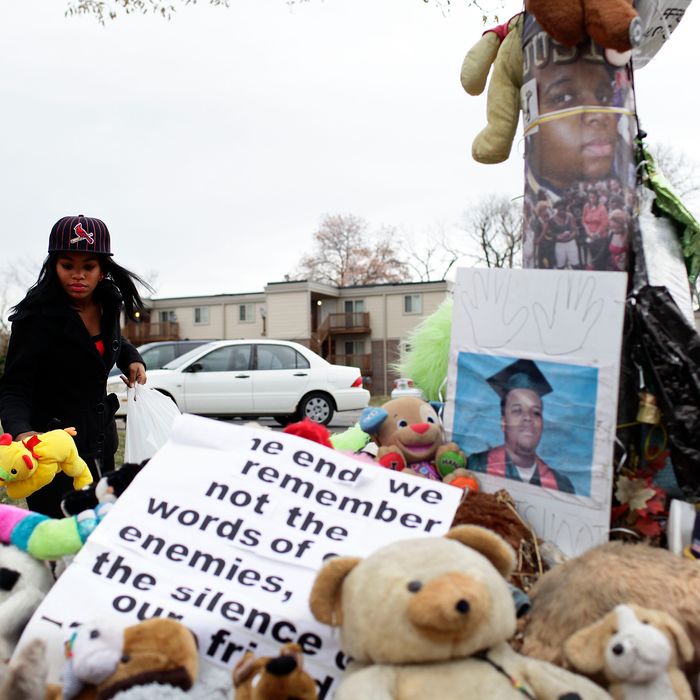 FERGUSON, MO - NOVEMBER 22: Marneisha Jones places a stuff animal at a makeshift memorial for Michael Brown November 22, 2014 in Ferguson, Missouri. Brown, a 18-year-old black male teenager was fatally wounded by Darren Wilson, a white Ferguson Police officer on August 9, 2014. A 12-member grand jury is reviewing evidence to decide whether or not to indict Wilson on charges. (Photo by Joshua Lott/Getty Images)