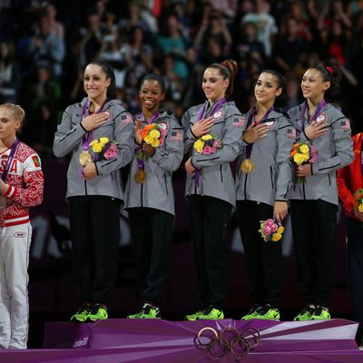 Jordyn Wieber, Gabrielle Douglas, Mc Kayla Maroney, Alexandra Raisman and Kyla Ross of the United States celebrate on the podium after winning the gold medal in the Artistic Gymnastics Women's Team final on Day 4 of the London 2012 Olympic Games at North Greenwich Arena on July 31, 2012 in London, England. 