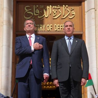 Visiting U.S. Defense Secretary Ash Carter, left, and his Iraqi counterpart Khaled al-Obeidi stand for their country's national anthems during a welcome ceremony at the Ministry of Defense, Baghdad, Iraq, Monday, April 18, 2016. (AP Photo)
