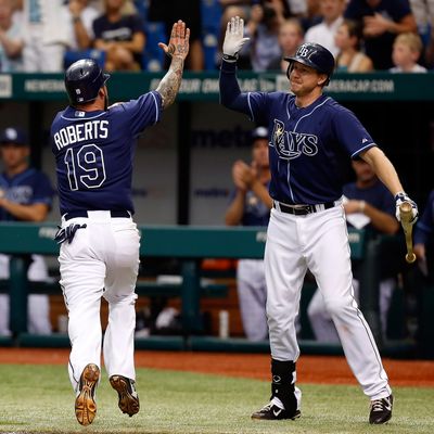 Infielder Ryan Roberts #19 of the Tampa Bay Rays is congratulated by Elliot Johnson #9 after scoring the winning run against the New York Yankees during the game at Tropicana Field on September 3, 2012 in St. Petersburg, Florida. 