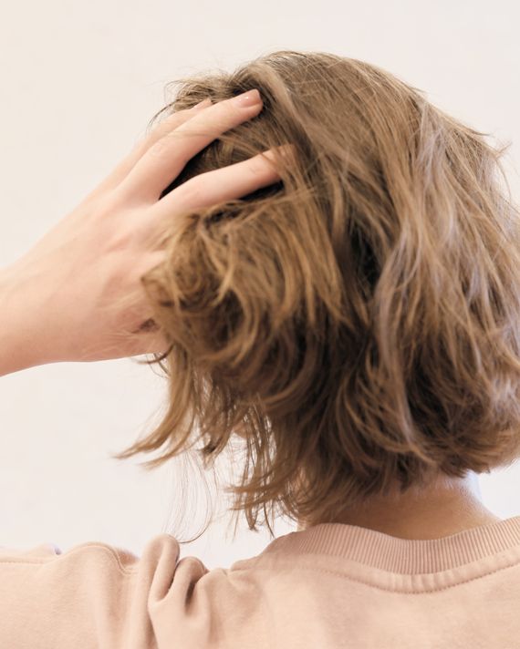 Back,View,Of,A,Woman,With,Hair,Oil,Bottle.,Woman