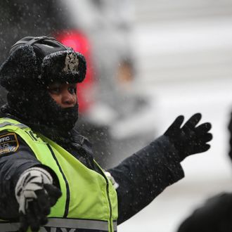 NEW YORK, NY - JANUARY 21: A police officer directs traffic at Union Square during a snowstorm on January 21, 2014 in New York City. Areas of the Northeast are predicted to receive up to a foot of snow in what may be the biggest snowfall of the season so far. (Photo by John Moore/Getty Images)