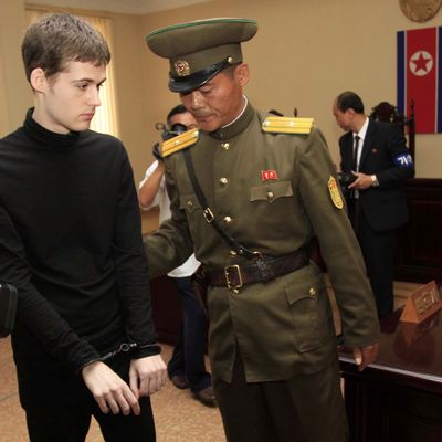 Handcuffed Matthew Miller, a U.S. citizen, leaves after his trial at the Supreme Court in Pyongyang, North Korea, Sunday, Sept. 14, 2014. North Korea's Supreme Court on Sunday sentenced Miller to six years of hard labor for entering the country illegally and trying to commit espionage. (AP Photo/Kim Kwang Hyon)