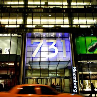 A taxi passes by the residential and office tower located at 731 Lexington Avenue, which houses the offices of Bloomberg News parent Bloomberg L.P., in New York