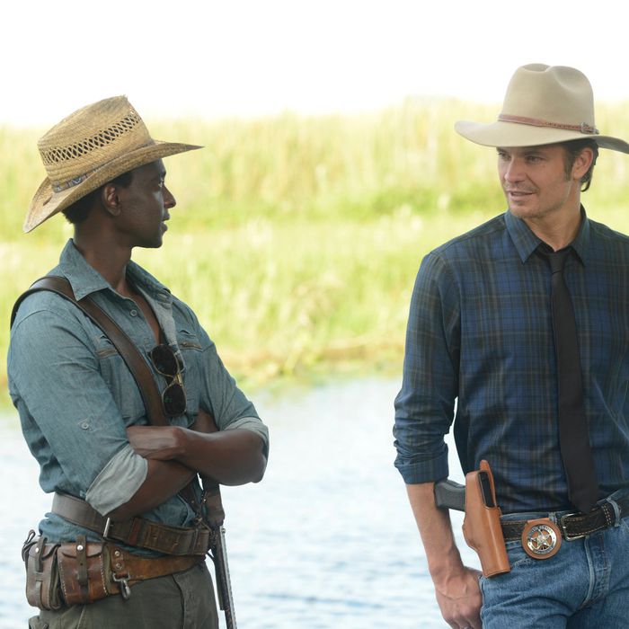 JUSTIFIED -- A Murder of Crowes -- Episode 501 (Airs Tuesday, January 7, 10:00 pm e/p) -- Pictured: (L-R) Edi Gathegi as Jean Baptiste, Timothy Olyphant as Deputy U.S. Marshal Raylan Givens -- CR: Guy D'Alama/FX