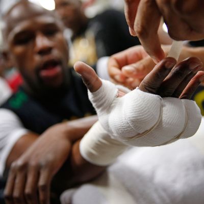 Floyd Mayweather Jr. gets taped up before a workout Tuesday, April 14, 2015, in Las Vegas. Mayweather is scheduled to face Manny Pacquiao in a welterweight boxing match in Las Vegas on May 2. (AP Photo/John Locher)