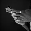 Close up shot of unrecognizable woman typing a text message on a small phone