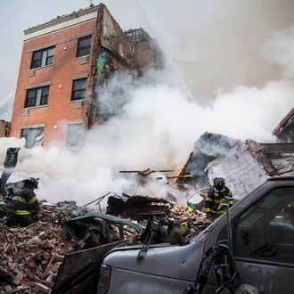 NEW YORK, NY - MARCH 12: Heavy smoke pours from the debris as the Fire Department of New York (FDNY) responds to a 5-alarm fire and building collapse at 1646 Park Ave in the Harlem neighborhood of Manhattan March 12, 2014 in New York City. Reports of an explosion were heard before the collapse of two multiple-dwelling buildings that left at least 11 injured. (Photo by Andrew Burton/Getty Images)