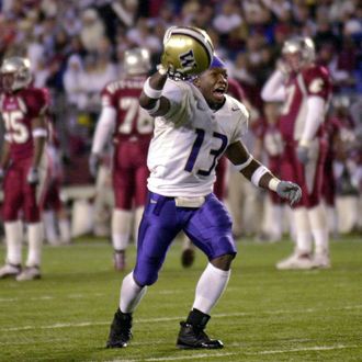 Nate Robinson of the Washington Huskies celebrates after defeating the Washington State Cougars 29-26 in triple overtime on November 23, 2002.