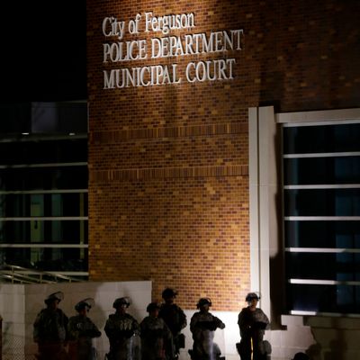 Guardsmen stand in front the Ferguson Police Department Municipal Court bulding, Tuesday, Nov. 25, 2014, in Ferguson, Mo. Missouri's governor ordered hundreds more state militia into the St. Louis suburb, Ferguson, Tuesday after a night of protests and rioting over a grand jury decision's not to indict police officer Darren Wilson in the killing of Michael Brown, a case that has inflamed racial tensions in the U.S. (AP Photo/Charlie Riedel)