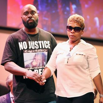 FERGUSON, MO - AUGUST 17: Michael Brown Sr. and Lesley McSpadden, the parents of slain teenager Michael Brown, attend a rally at Greater Grace Church on August 17, 2014 in Ferguson, Missouri. Their son was shot and killed by a Ferguson police officer on August 9. Despite the Brown family's continued call for peaceful demonstrations, violent protests have erupted nearly every night in Ferguson since his death. (Photo by Scott Olson/Getty Images)