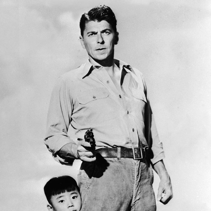 Chinese child actor Danny Chang clings to the leg of American actor and politician Ronald Reagan (1911 - 2004) in a publicity still for the feature film 'Hong Kong' directed by Lewis R. Foster, 1951.