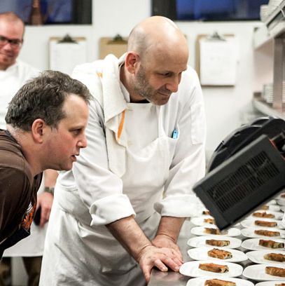 Chefs Paul Kahan and Marc Vetri review the menu before service.