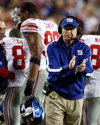 Head coach Tom Coughlin of the New York Giants reacts after the Giants score in the second quarter while taking on the Washington Redskins at FedExField on December 3, 2012 in Landover, Maryland.