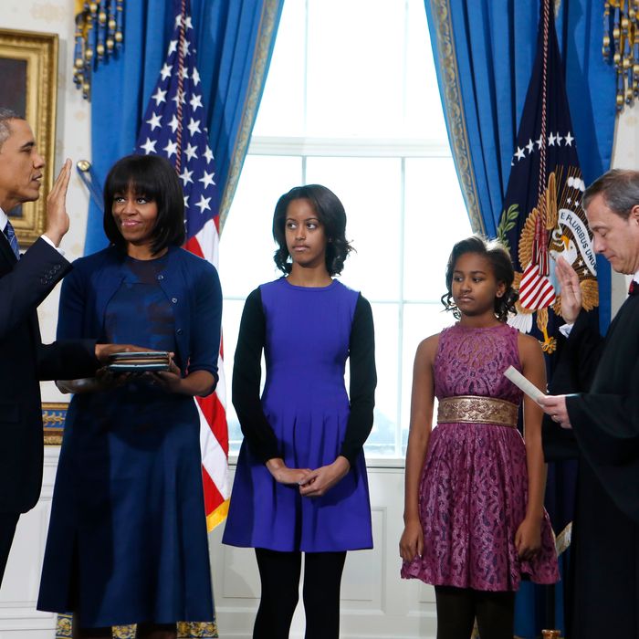 WASHINGTON - JANUARY 20: U.S President Barack Obama (L) takes the oath of office from U.S. Supreme Court Chief Justice John Roberts (R) as first lady Michelle Obama (2nd L) holds the bible and daughter Malia (C) and Sasha looks on in the Blue Room of the White House January 20, 2013 in Washington, DC. Obama and U.S. Vice President Joe Biden were officially sworn in a day before the ceremonial inaugural swearing-in. (Photo by Larry Downing-Pool/Getty Images)