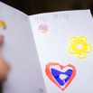 Child's hands holding card for Mother's day